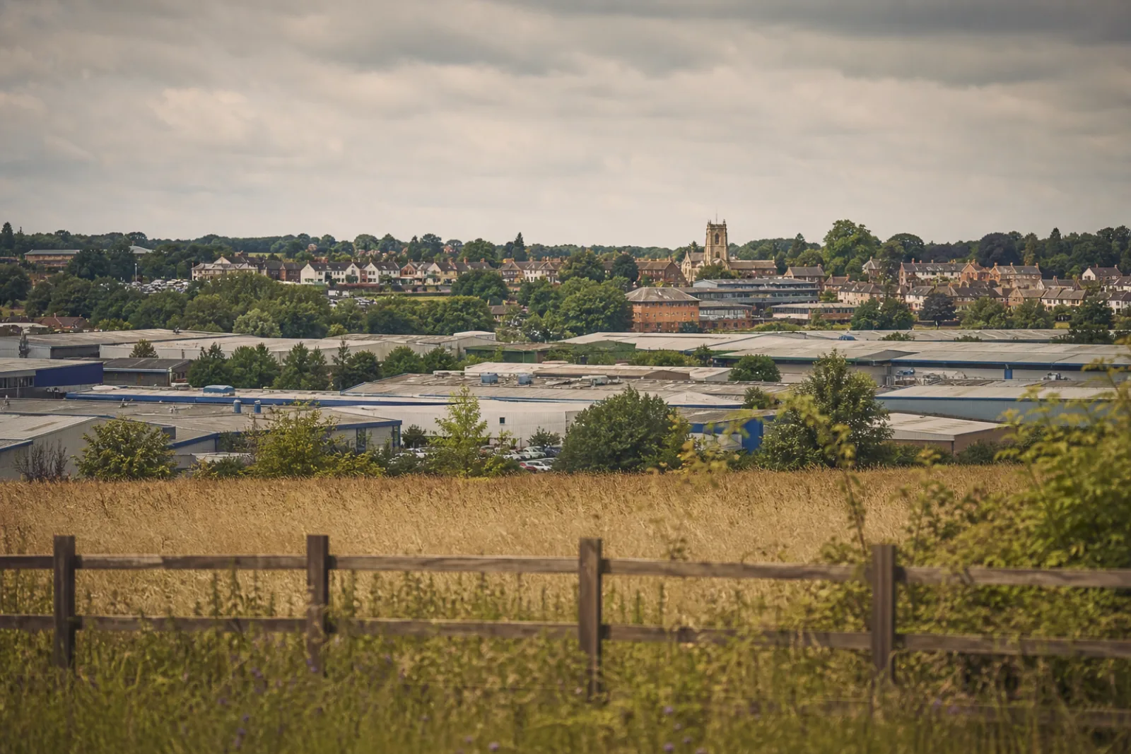 Sittingbourne's industrial estates and rooftops seen across farmland at the edge of town